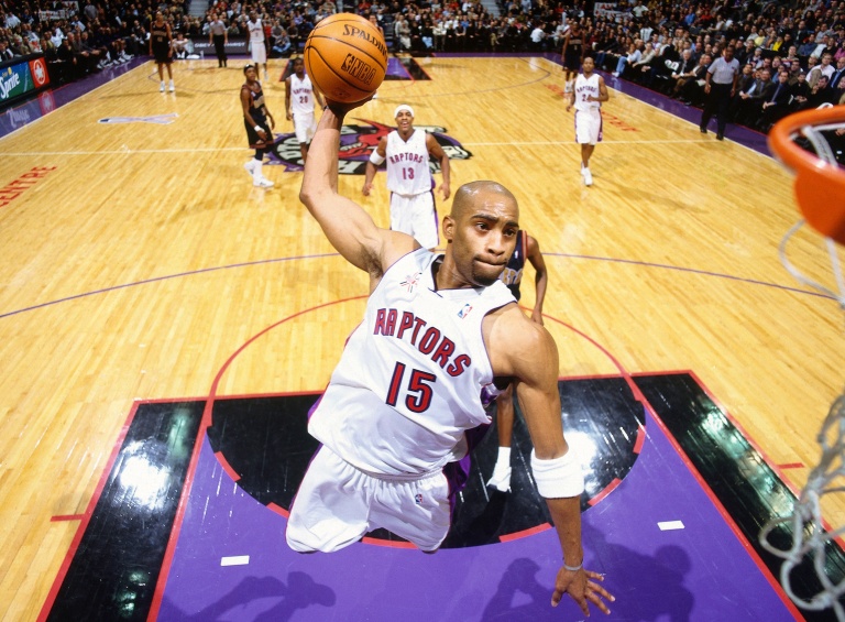 TORONTO, CANADA - 2001: Vince Carter #15 of the Toronto Raptors dunks the ball against the Denver Nuggets at Air Canada Centre in Toronto, Canada circa 2001. NOTE TO USER: User expressly acknowledges and agrees that, by downloading and/or using this Photograph, user is consenting to the terms and conditions of the Getty Images License Agreement. Mandatory Copyright Notice: Copyright 1991 NBAE (Photo by Nat Butler/NBAE via Getty Images)